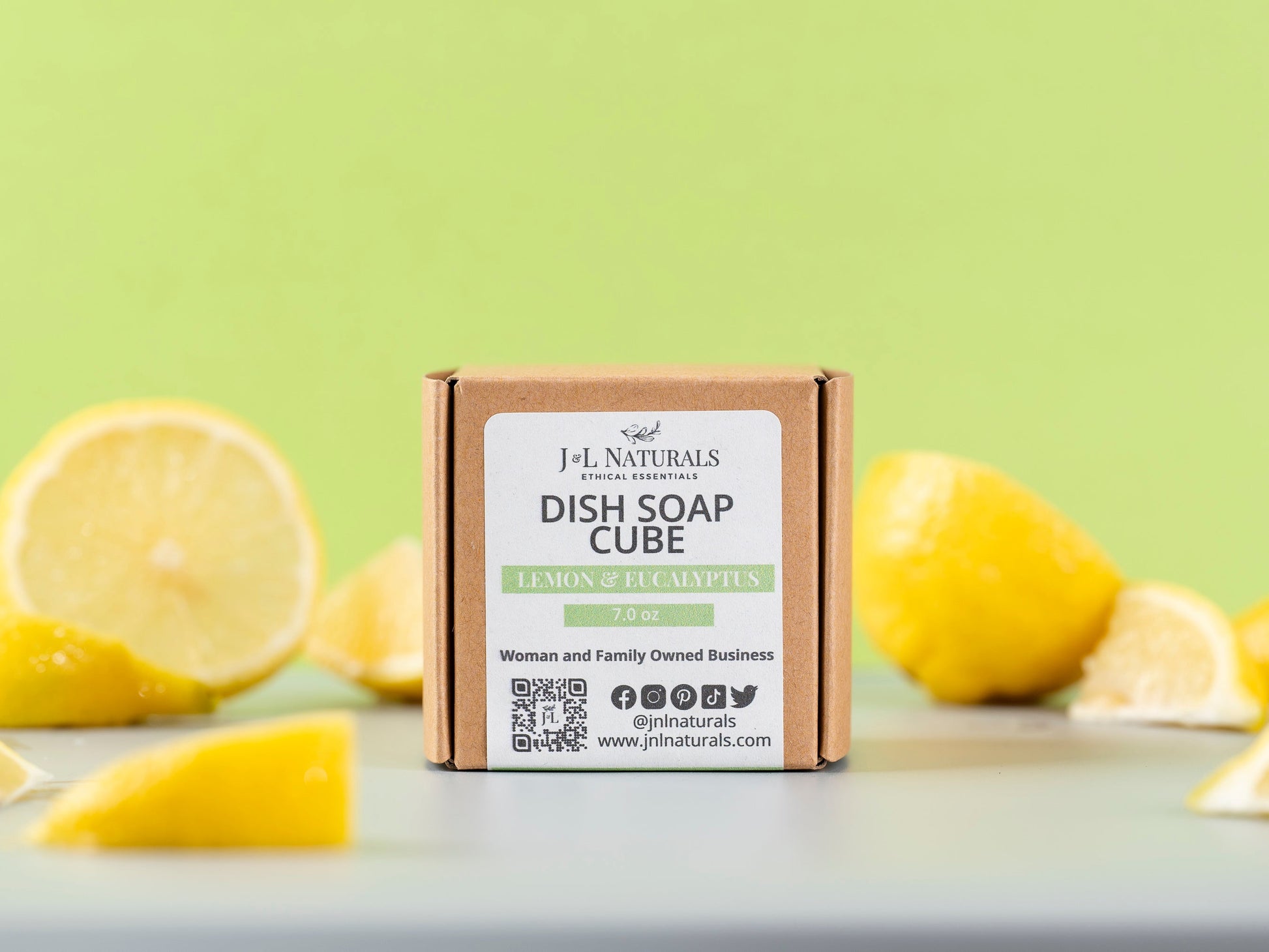 Dish soap cube with lemons on a light green background